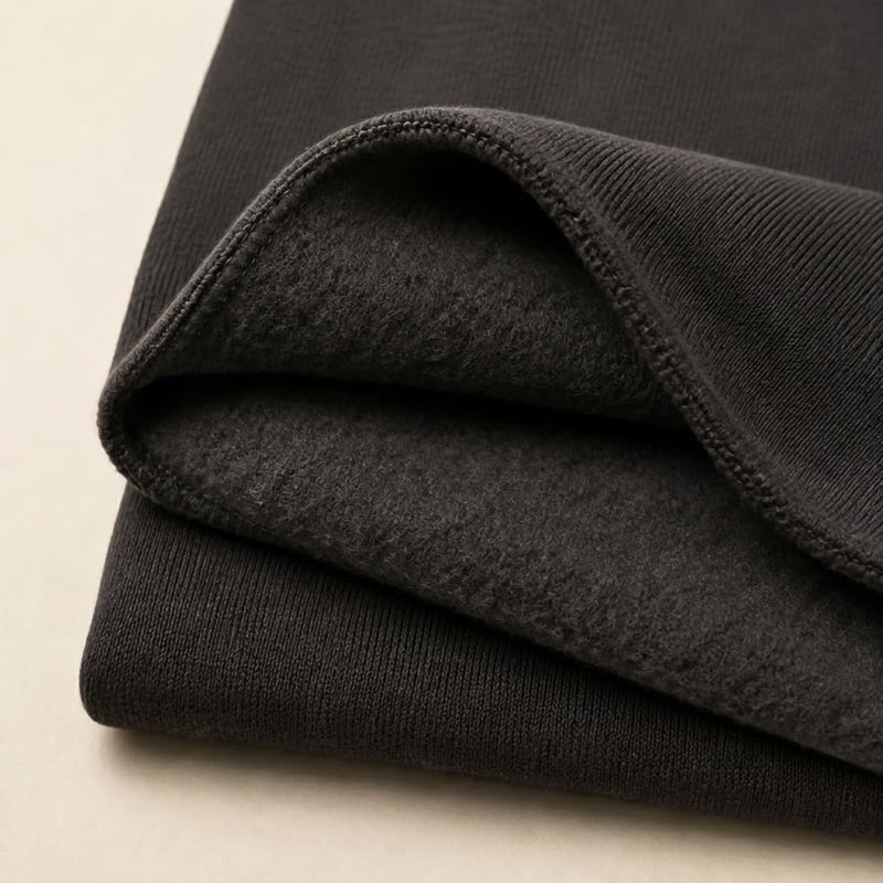 Dark charcoal brushed fleece fabric with a soft and warm inner surface